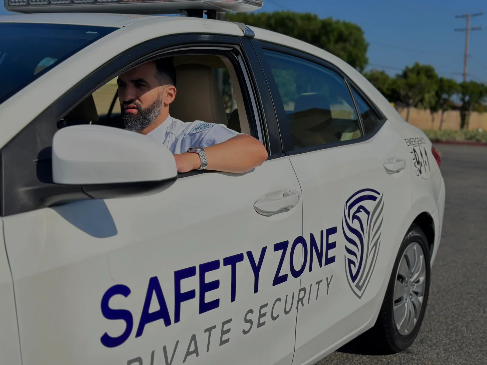Safety Zone patrol officer in a marked patrol car with light bar